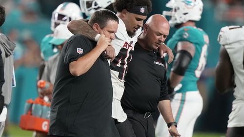 Atlanta Falcons linebacker Bralen Trice (48) is assisted off the field during the first half of a preseason NFL football game against the Miami Dolphins, Friday, Aug. 9, 2024, in Miami Gardens, Fla. (AP Photo/Lynne Sladky)