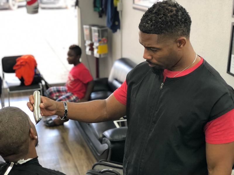 Dwight Buckner cuts hair at Vision’s Barber Shop in Decatur on Friday, Aug. 2, 2019. (MARLON A. WALKER / marlon.walker@ajc.com)