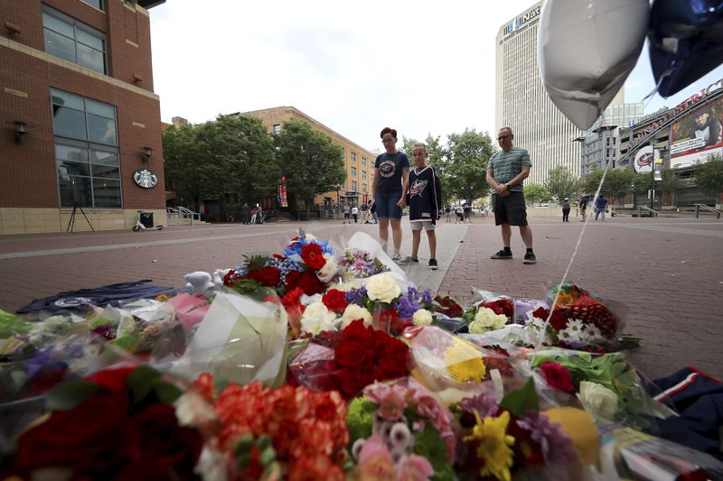 From left; Jamie, Gavin and John Rose pay their respects at a memorial set up by fans for Blue Jackets hockey player Johnny Gaudreau in Columbus, Ohio, Aug. 30, 2024. Gaudreau, along with his brother Matthew, was fatally struck by a motorist while riding his bicycle on Thursday. (AP Photo/Joe Maiorana)