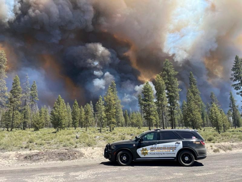In this photo provided by the Deschutes County Sherriff's Office, smoke rises from a wildfire near La Pine, Oregon, Tuesday, June 25, 2024. Gusty winds fueled a rapidly growing wildfire just outside the central Oregon community of La Pine and prompted evacuations. (Sgt. Kyle Kalambach/Deschutes County Sherriff's Office via AP)