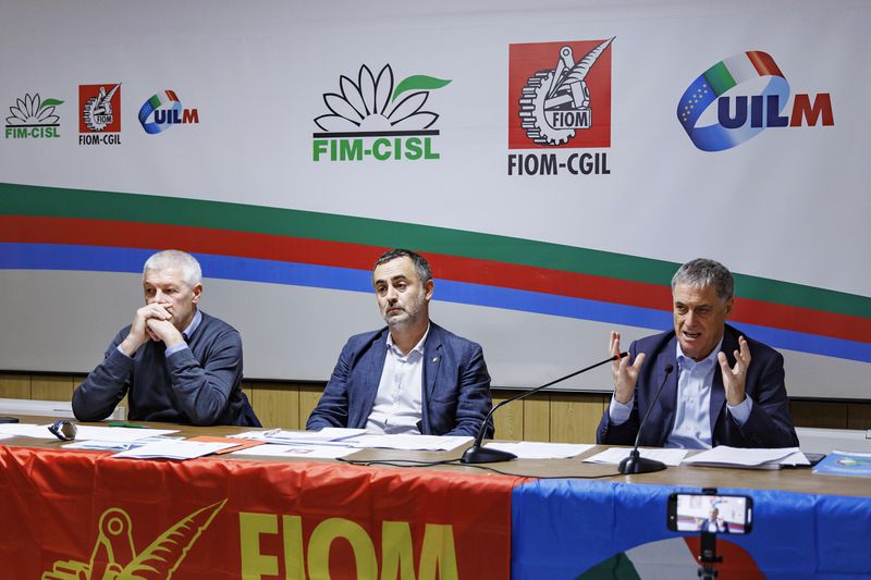 Fernando Uliano of Fim Cisl union, left, Michele De Palma of Fiom Cgil union, centre, and Rocco Palombella of Uilm union hold a news conference to announce the mobilization of Stellantis workers and the entire automotive supply chain, in Rome, Tuesday, Sept. 24, 2024. (Roberto Monaldo/LaPresse via AP)