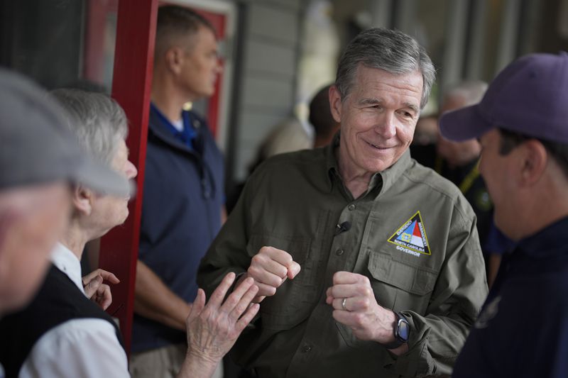 North Carolina governor Roy Cooper greets people on Thursday, Oct. 3, 2024, in Boone, N.C. in the aftermath of hurricane Helene. In the final weeks of the presidential election, people in North Carolina and Georgia, influential swing states, are dealing with more immediate concerns: recovering from Hurricane Helene. (AP Photo/Chris Carlson)