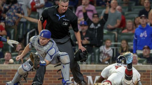 Los Angeles Dodgers catcher Will Smith, left, watches the ball come in as Atlanta Braves' Michael Harris II, right, slides into home in the third inning of a baseball game, Monday, Sept. 16, 2024, in Atlanta. (AP Photo/Jason Allen)