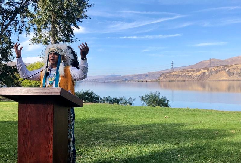 FILE - JoDe Goudy, chairman of the Yakama Nation, speaks with the Columbia River in the background near The Dalles, Oregon, Monday, Oct. 14, 2019, where Celilo Falls, an ancient salmon fishing site was destroyed by the construction of the Dalles Dam in the 1950s. The U.S. government on Tuesday, June 18, 2024, acknowledged for the first time the harms that the construction and operation of dams on the Columbia and Snake rivers in the Pacific Northwest have caused Native American tribes, issuing a report that details how the unprecedented structures devastated salmon runs, inundated villages and burial grounds, and continue to severely curtail the tribes' ability to exercise their treaty fishing rights. (AP Photo/Gillian Flaccus, File)