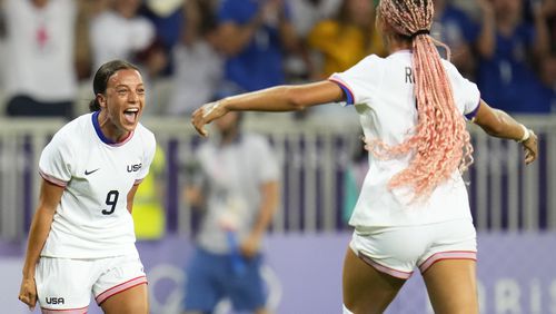 United States' Mallory Swanson, left, reacts after teammate Trinity Rodman, right, scored a goal during a women's group B match between the United States and Zambia at Nice Stadium at the 2024 Summer Olympics, Thursday, July 25, 2024, in Nice, France. (AP Photo/Julio Cortez)