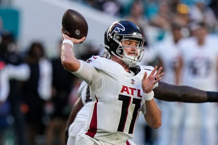 Atlanta Falcons quarterback Logan Woodside (11) calls the count at