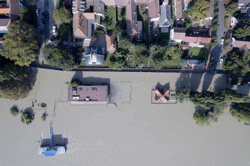 An aerial picture taken with a drone shows a flooded area and the swollen Danube River in Kisoroszi, Hungary, Wednesday, Sept. 18, 2024. (Gergely Janossy/MTI via AP)