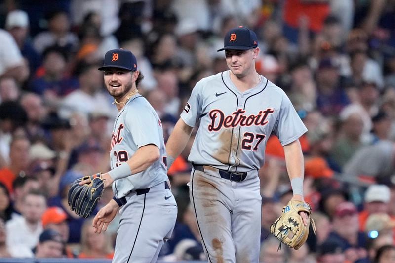 Detroit Tigers third baseman Zach McKinstry (39) and shortstop Trey Sweeney (27) celebrate after completing a double play that off a ground ball by Houston Astros' Yainer Diaz in the sixth inning of Game 2 of an AL Wild Card Series baseball game Wednesday, Oct. 2, 2024, in Houston. (AP Photo/Kevin M. Cox)