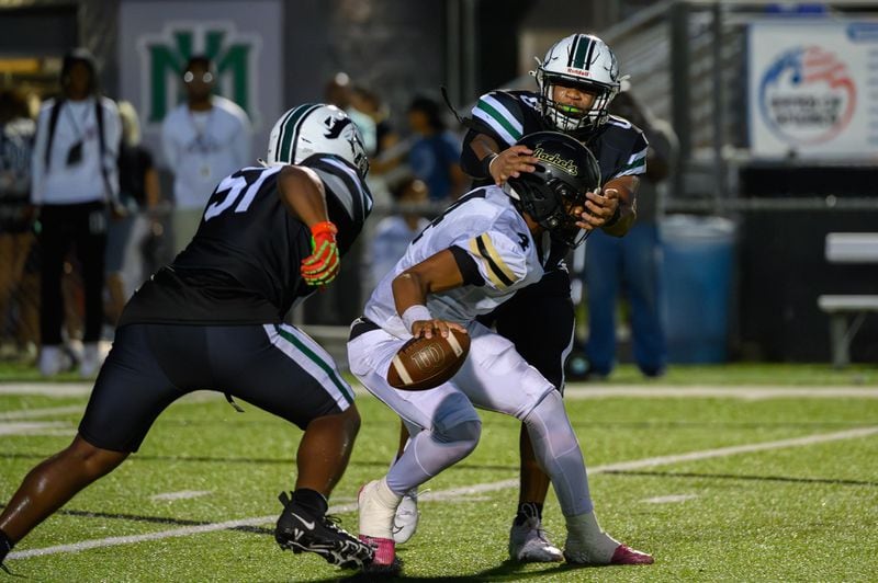 Jaden Duckett, quarterback for Sprayberry High School, escapes a sack during an Aug. 30 game against Kennesaw Mountain.