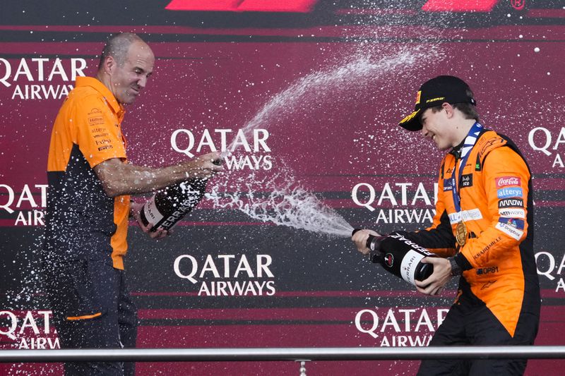 McLaren driver Oscar Piastri of Australia, right, and McLaren chief engineer Tom Stallardcelebrate after he won the Formula One Grand Prix in Baku, Azerbaijan, on Sunday, Sept. 15, 2024. (AP Photo/Sergei Grits)