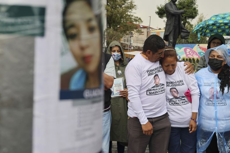 Husband and wife Marcos Vazquez and Benita Ornelas, from the search collective "Uniendo Esperanzas" or Uniting Hope, attend an Anglican Mass on the fifth anniversary of the disappearance of their son Fernando Ivan Ornelas in Mexico City, Sunday, July 21, 2024. (AP Photo/Ginnette Riquelme)