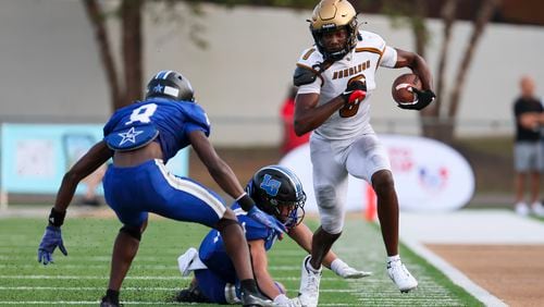 Douglass wide receiver Jontae Gilbert (0) runs after a catch against LaGrange defender during the second half in the Corky Kell Dave Hunter Classic at Kell High School, Wednesday, August 14, 2024, in Marietta, Ga. Douglass won 18-3. (Jason Getz / AJC)
