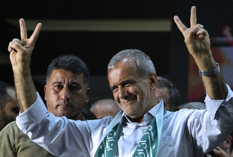 Reformist candidate for Iran's June 28, presidential election Masoud Pezeshkian flashes the victory sign in his campaign rally in Tehran, Iran, Sunday, June 23, 2024. (AP Photo/Vahid Salemi)