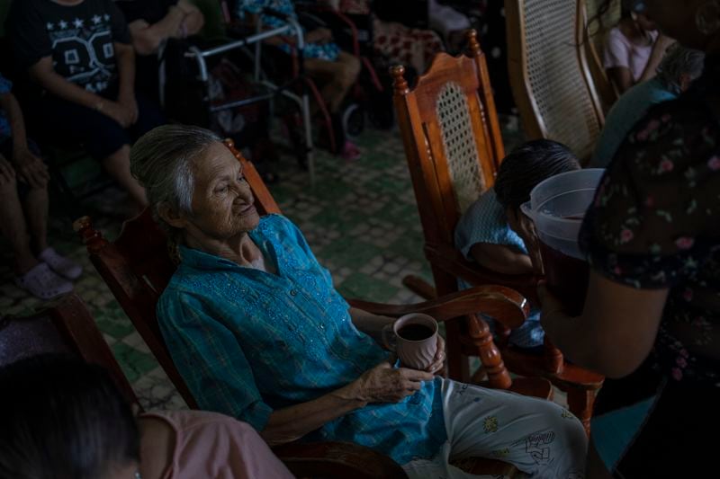 Rosalinda Murguia, 80, receives flavored water during a heat wave in the Cogra nursing home in Veracruz, Mexico, Sunday, June 16, 2024. Victims in Veracruz have made up nearly a third of Mexico's heat-related deaths as temperatures have reached 100 degrees in the humid Mexican gulf state. (AP Photo/Felix Marquez)