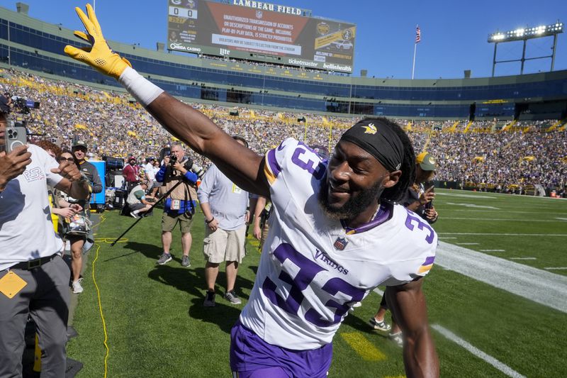 Minnesota Vikings running back Aaron Jones (33) waves to fans before an NFL football game against the Green Bay Packers, Sunday, Sept. 29, 2024, in Green Bay, Wis. (AP Photo/Morry Gash)