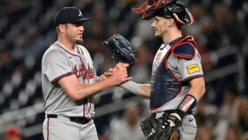 Braves relief pitcher Luke Jackson, left, is congratulated by catcher Sean Murphy after finishing off the ninth inning to defeat the Washington Nationals in a baseball game, Tuesday, Sept. 10, 2024, in Washington. The Braves won 12-0. (AP Photo/John McDonnell)