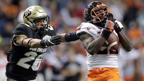 Oklahoma State wide receiver James Washington (28) pulls in a pass in front of Colorado defensive back Isaiah Oliver (26) during the second half of the Alamo Bowl NCAA college football game, Thursday, Dec. 29, 2016, in San Antonio. (AP Photo/Eric Gay)