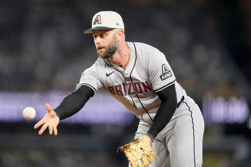 Arizona Diamondbacks first baseman Christian Walker throws out Los Angeles Dodgers' Gavin Lux at first during the eighth inning of a baseball game, Thursday, July 4, 2024, in Los Angeles. (AP Photo/Ryan Sun)