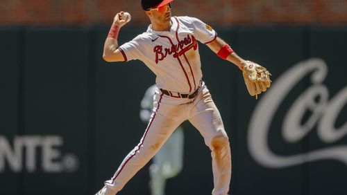 Atlanta Braves second baseman Whit Merrifield throws a runner out at first base in the sixth inning of a baseball game against the Washington Nationals, Sunday, Aug. 25, 2024, in Atlanta. (AP Photo/Jason Allen)