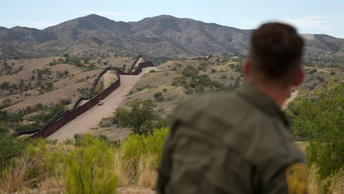 FILE - Border patrol agent Pete Bidegain looks from a hilltop on the U.S. side of the US-Mexico border in Nogales, Ariz. on Tuesday, June 25, 2024. (AP Photo/Jae C. Hong, Pool, File)