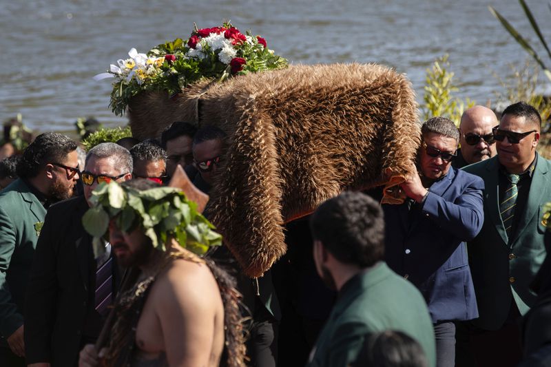 The coffin with the body of New Zealand's Maori King, Kiingi Tuheitia Pootatau Te Wherowhero VII, is carried up Taupiri Mountain for burial in Ngaruawahia, New Zealand, Thursday, Sept. 5, 2024. (AP Photo/Alan Gibson)