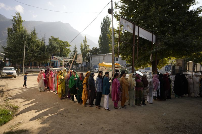 People queue up to cast their vote at a polling booth during the first phase of the Jammu and Kashmir Assembly election, in Kishtwar, India, Wednesday, Sept. 18, 2024. (AP Photo/Channi Anand)