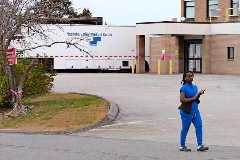 A worker from a nearby retirement home walks on her lunch break past the emergency room ramp at the former Nashoba Valley Medical Center, which closed on Aug. 31, 2024 and was part of the bankrupt Steward Health Care company, Thursday, Sept. 19, 2024, in Ayer, Mass. (AP Photo/Charles Krupa)