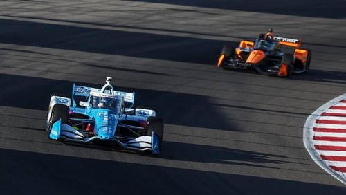 Josef Newgarden, left, drives during an IndyCar auto race on Saturday, Aug. 17, 2024, at World Wide Technology Raceway in Madison, Ill. (Zachary Linhares/St. Louis Post-Dispatch via AP)