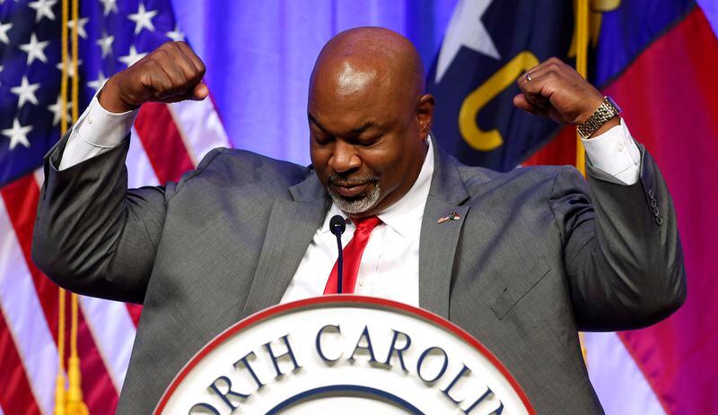 Lt. Gov. Mark Robinson flexes after telling the audience that he has lost 80 pounds at the North Carolina GOP Convention in Greensboro, N.C., on Saturday, May 25, 2024. (Woody Marshall/News & Record via AP)