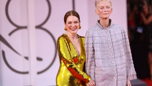 Julianne Moore, left, and Tilda Swinton pose for photographers upon arrival for the premiere of the film 'The Room Next Door' during the 81st edition of the Venice Film Festival in Venice, Italy, on Monday, Sept. 2, 2024. (Photo by Vianney Le Caer/Invision/AP)