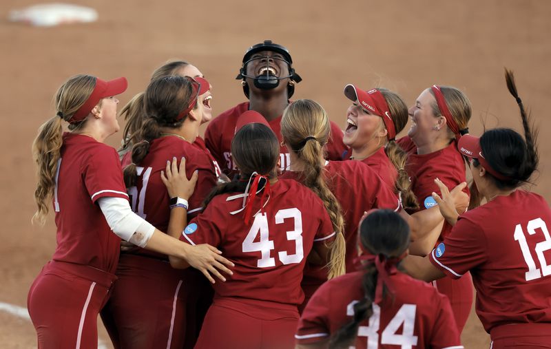 Stanford teammates swarm around pitcher NiJaree Canady (24) after the final out of the double elimination game as the Stanford Cardinal played the CSU Fullerton Titans in an NCAA softball regional tournament at Stanford, Calif., on Sunday May 19, 2024. Stanford won 4-2 and will advance.(Carlos Avila Gonzalez/San Francisco Chronicle via AP)