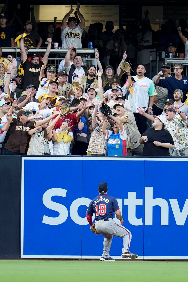 Atlanta Braves left fielder Ramón Laureano watches a home run ball from San Diego Padres' Kyle Higashioka go over the wall during the second inning in Game 2 of an NL Wild Card Series baseball game Wednesday, Oct. 2, 2024, in San Diego. (AP Photo/Gregory Bull)