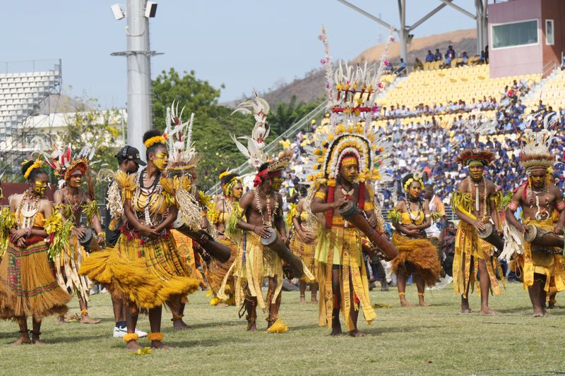 Dancers in traditional dress perform as Pope Francis gives an address during meeting with young people in the Sir John Guise Stadium in Port Moresby, Papua New Guinea, Monday, Sept. 9, 2024. (AP Photo/Mark Baker)