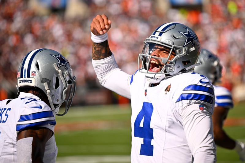 Dallas Cowboys quarterback Dak Prescott (4) celebrates after throwing a touchdown pass to wide receiver Brandin Cooks, left, in the first half of an NFL football game against the Cleveland Browns in Cleveland, Sunday, Sept. 8, 2024. (AP Photo/David Richard)