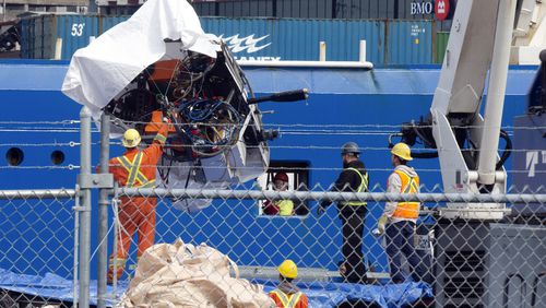 FILE - Debris from the Titan submersible, recovered from the ocean floor near the wreck of the Titanic, is unloaded from the ship Horizon Arctic at the Canadian Coast Guard pier in St. John's, Newfoundland, Wednesday, June 28, 2023. The U.S. Coast Guard will hold a long-awaited public hearing about the deadly Titanic submersible disaster in September as it continues its investigation into the implosion of the vessel. (Paul Daly/The Canadian Press via AP, File)