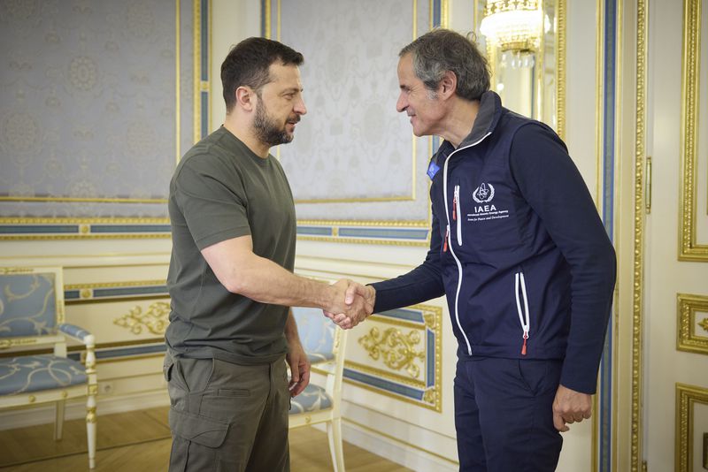 In this photo provided by the Ukrainian Presidential Press Office, Ukrainian President Volodymyr Zelenskyy, left, shakes hands with Director General of the International Atomic Energy Agency (IAEA), Rafael Mariano Grossi in Kyiv, Ukraine, Tuesday, Sept. 3, 2024. (Ukrainian Presidential Press Office via AP)