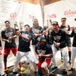 Atlanta players celebrate with champagne after their  3-0 win over the Mets in the second game of Monday’s doubleheader at Truist Park to clinch the 2024 MLB playoffs on Monday, Sept. 30, 2024, in Atlanta. 
(Miguel Martinez/ AJC)