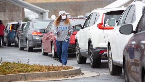 Cars line up to receive a COVID-19 vaccine shot at a vaccination center in Doraville. 
 STEVE SCHAEFER FOR THE ATLANTA JOURNAL-CONSTITUTION