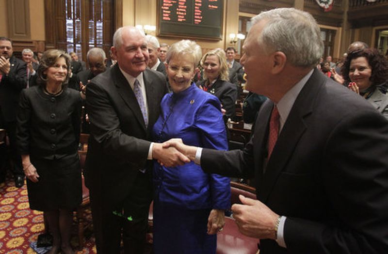 Outgoing Gov. Sonny Perdue, left, congratulates new Gov. Nathan Deal after he was sworn into office in January 2011. At the end of Perdue's second term, the Great Recession began, leading to billions of dollars in spending cuts, furloughs, job reductions and skyrocketing college tuition increases. The impact continued to play out during much of Deal's time in office. (AJC file, Bob Andres / bob.andres@ajc.com)