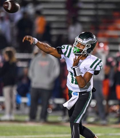 Collins Hill quarterback TJ Wilcox (12) completes a pass against North Cobb during the second half of play Friday, Nov. 10, 2023 at North Cobb High School. (Daniel Varnado/For the AJC)