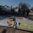 Ukrainian servicemen examine fragments of a Russian military plane that was shot down on the outskirts of Kostyantynivka, a near-front line city in the Donetsk region, Ukraine, Saturday, Oct. 5, 2024. (Iryna Rybakova via AP)