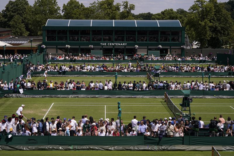 FILE - Play takes place on the outside courts on day four of the Wimbledon tennis championships in London, Thursday, July 6, 2023. This year's Wimbledon tournament begins on Monday, July 1.(AP Photo/Alberto Pezzali, File)