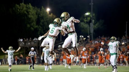 August 20, 2021 - Kennesaw, Ga: Buford wide receiver Tobi Olawale (4) celebrates his receiving touchdown with running back Victor Venn (6) during the second half against North Cobb at North Cobb high school Friday, August 20, 2021 in Kennesaw, Ga.. Buford won 35-27. JASON GETZ FOR THE ATLANTA JOURNAL-CONSTITUTION



