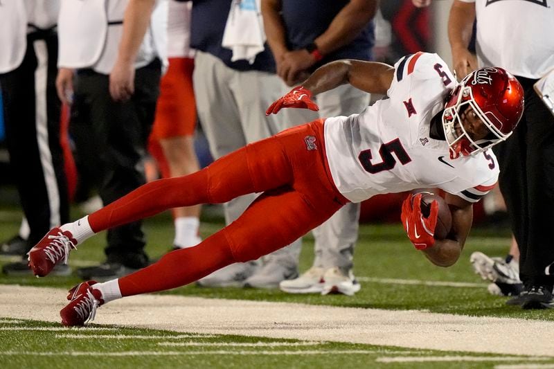 Arizona wide receiver Montana Lemonious-Craig falls after catching a pass out of bounds during the first half of an NCAA college football game against Kansas State Friday, Sept. 13, 2024, in Manhattan, Kan. (AP Photo/Charlie Riedel)