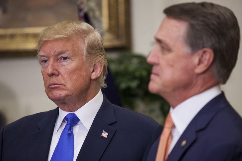 President Donald Trump, left, and U.S. Sen. David Perdue first met five years ago and worked closely since Trump took office in 2017. Perdue, who is up for re-election next year, plays up the connection on the campaign trail. “He calls me early in the morning and late at night. I spend time with him in the White House. Sometimes he’s exhausting, guys, but he works,” Perdue said of Trump at a recent gathering of religious conservatives. His opponents are also trying to tie him to the president. Photo by: Zach Gibson/picture-alliance/dpa/AP Images