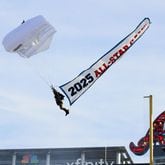 A parachute enters Truist Park Monday during the ceremonies for the unveiling of the 2025 All-Star Game logo.
(Miguel Martinez/ AJC)