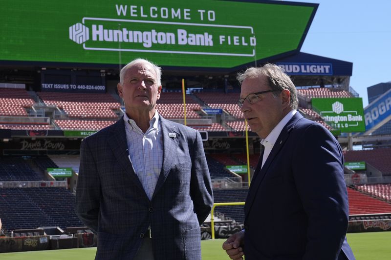 Cleveland Browns owner Jimmy Haslam, left, and Huntington Banks' Steve Steinour, right, Huntington Bank chairman, president and chief executive officer, speak following an NFL football news conference announcing Cleveland Browns Stadium will now be called Huntington Bank Field, Tuesday, Sept. 3, 2024, in Cleveland. (AP Photo/Sue Ogrocki)