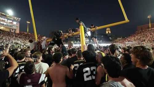 Vanderbilt fans tear down the goal post the after team's 40-35 win against Alabama in an NCAA college football game Saturday, Oct. 5, 2024, in Nashville, Tenn. (AP Photo/George Walker IV)