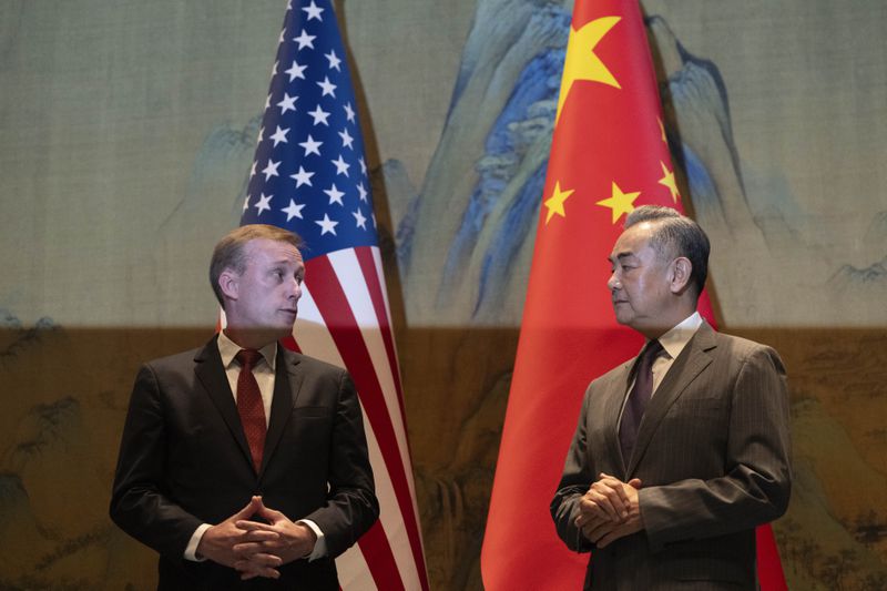 Wang Yi, right, the director of the Communist Party's Central Foreign Affairs Commission Office and White House national security adviser Jake Sullivan, left, look at each other before their talk at Yanqi lake in Beijing, Tuesday, Aug. 27, 2024. (AP Photo/Ng Han Guan, Pool)