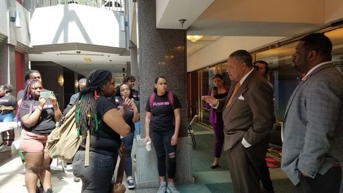 Fulton County commissioners Robb Pitts (center) and Marvin Arrington talk to protesters including Mary Hooks, co-director of Southerners on New Ground, about conditions at the jail. ARIELLE KASS/AKASS@AJC.COM